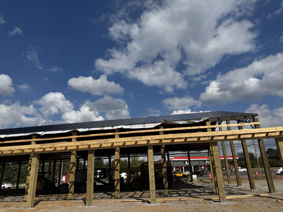 Overview of the Thompsons Station Hardware construction site in Franklin, TN, featuring the extensive wooden and steel skeleton of the new building.