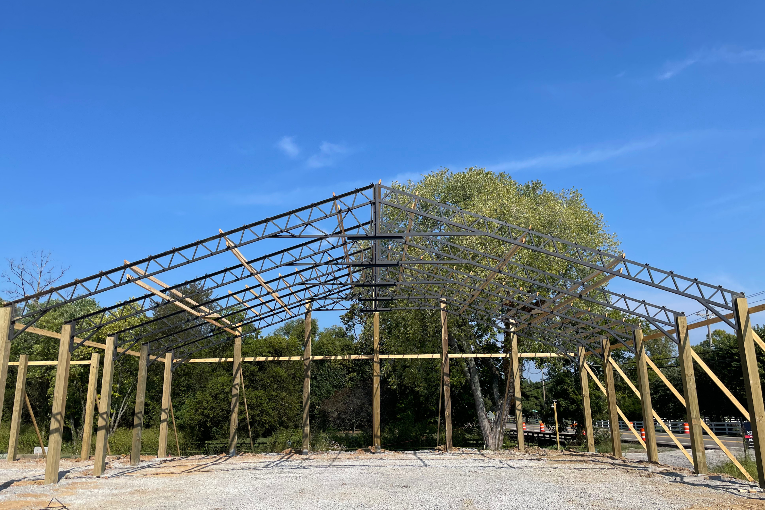 Latest construction progress showing completed framing awaiting roof installation and exterior siding for Thompson's Station Hardware